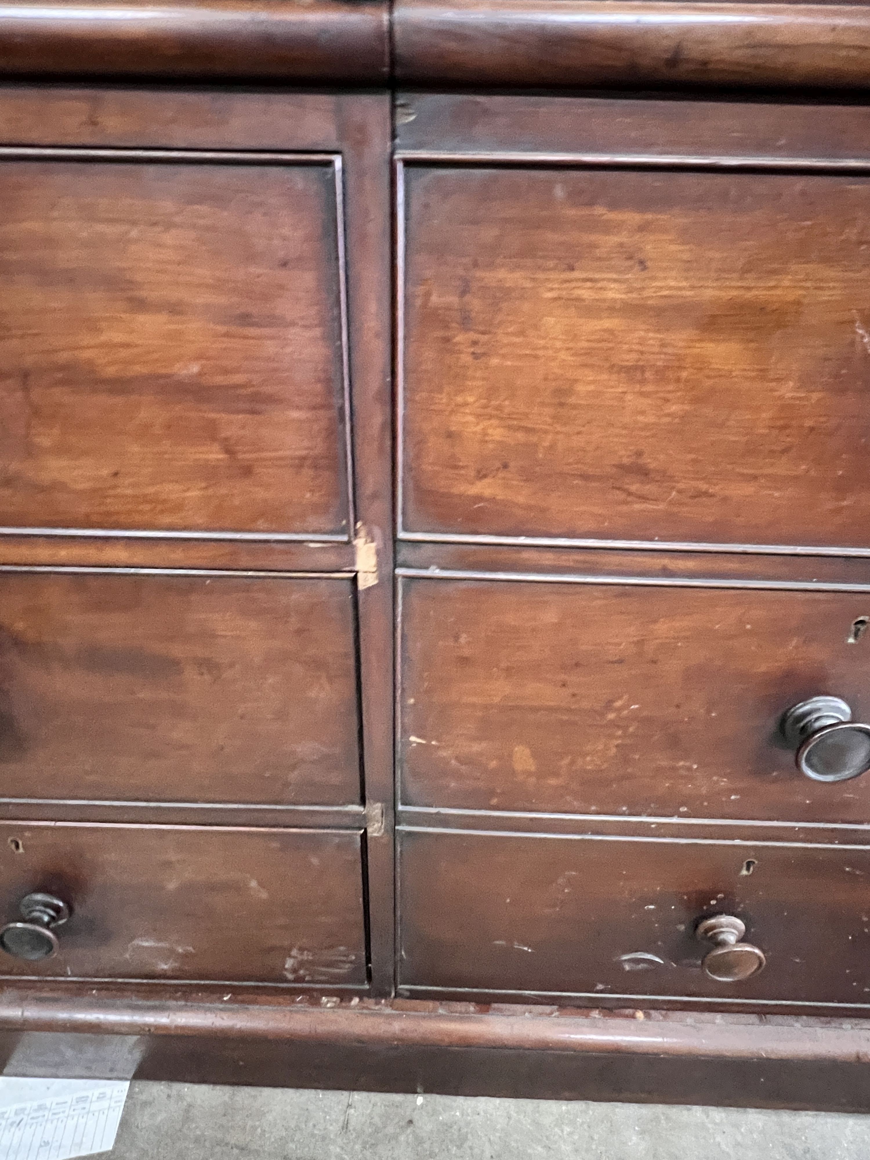 An early Victorian mahogany triple press cupboard, with three panelled doors over an arrangement of drawers and dummy drawers., width 178cm, depth 58cm, height 209cm